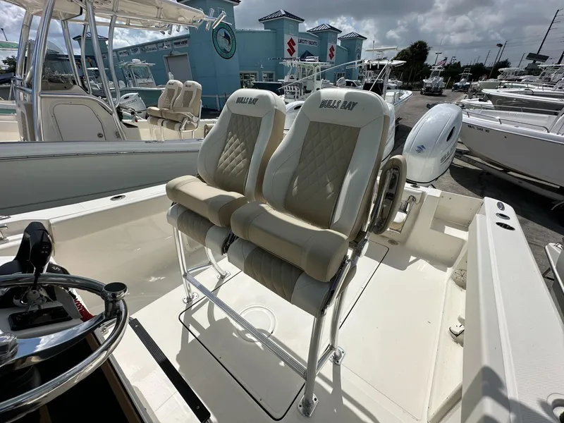 Slide: The Image of 2025 Bulls Bay 255 CC boat interior with dual seats and steering wheel. - 9