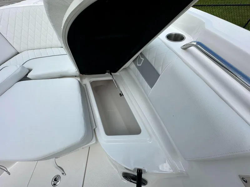 Slide: The Image of Open storage compartment on 2025 Sea Fox 268 Commander boat with white seating. - 13
