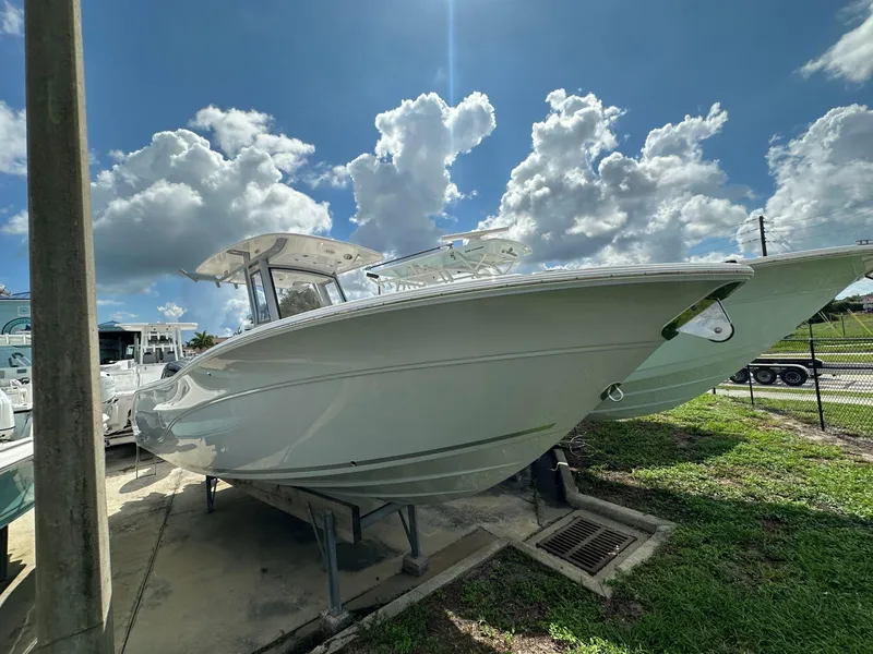 Slide: The Image of 2025 Sea Fox 268 Commander boat displayed outdoors under a cloudy sky. - 2