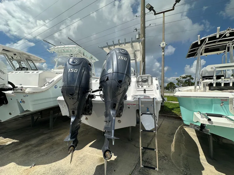 Slide: The Image of 2025 Sea Fox 268 Commander with dual 150 horsepower engines, docked under a cloudy sky. - 3