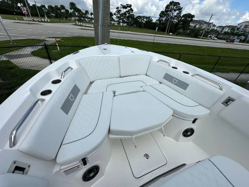 Slide: The Image of 2025 Sea Fox 268 Commander boat with white cushioned seating and cup holders. - 7