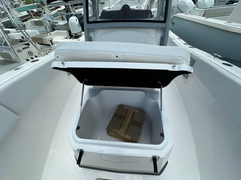 Slide: The Image of 2025 Sea Fox 268 Commander boat with open storage compartment, docked among other boats. - 8