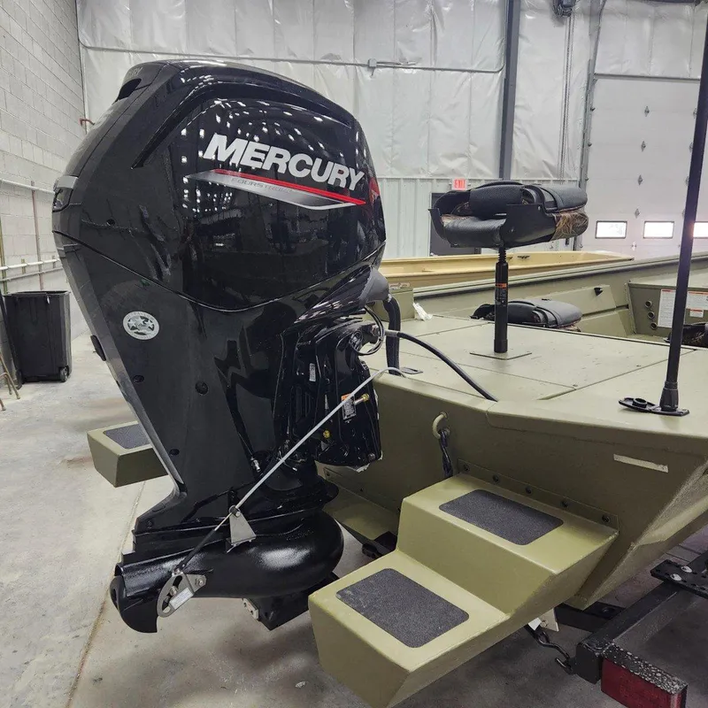 Slide: The Image of 2024 Crestliner 1860 Retriever SC with Mercury outboard motor in a garage. - 11