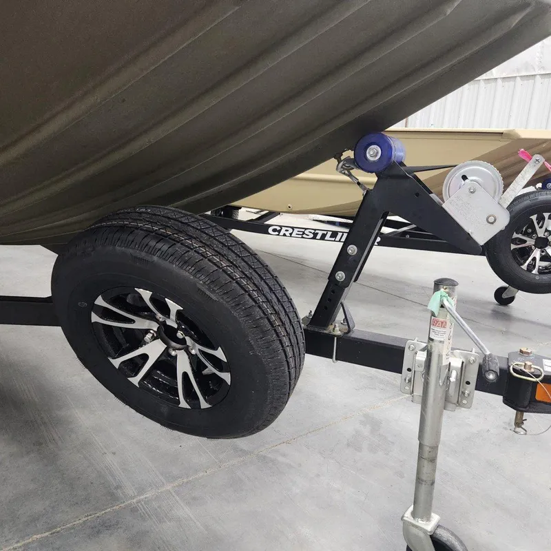 Slide: The Image of 2024 Crestliner 1860 Retriever SC boat trailer with black alloy wheels. - 15