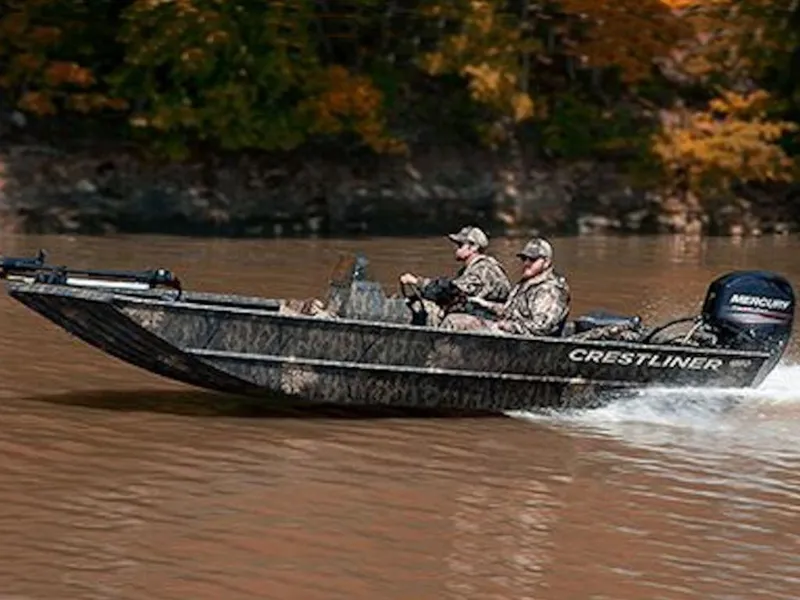 Slide: The Image of 2024 Crestliner 1860 Retriever SC boat cruising on a river with two passengers. - 3