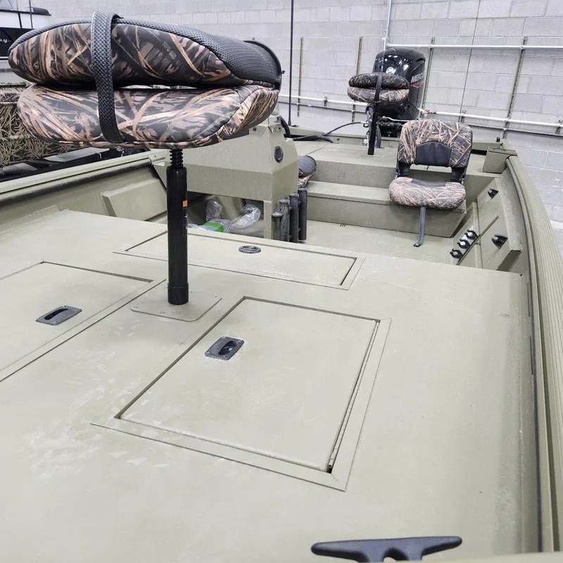 Slide: The Image of 2024 Crestliner 1860 Retriever SC boat with camo seats and storage compartments. - 6