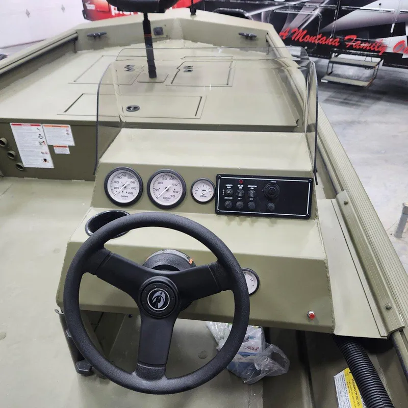 Slide: The Image of 2024 Crestliner 1860 Retriever SC boat dashboard with steering wheel and gauges. - 7