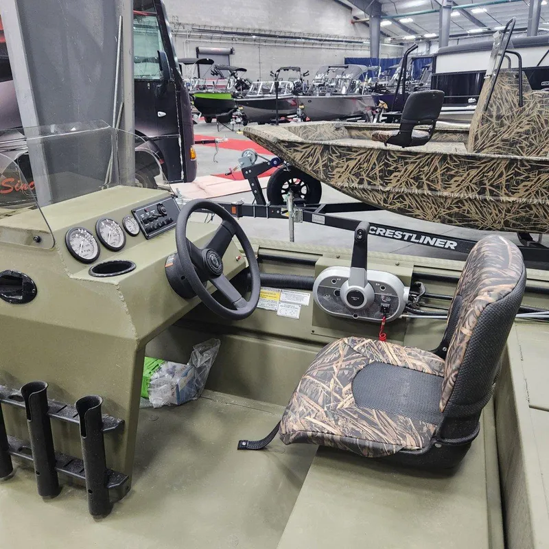 Slide: The Image of 2024 Crestliner 1860 Retriever SC boat interior with camo seat and steering console. - 8