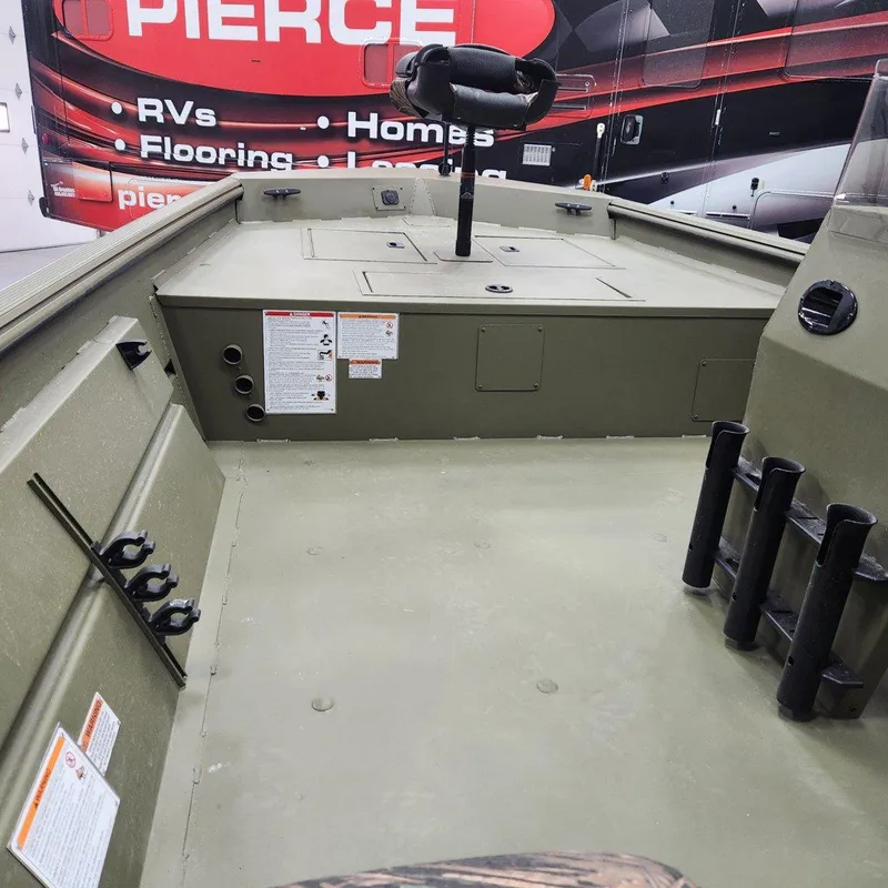 Slide: The Image of 2024 Crestliner 1860 Retriever SC interior with fishing rod holders and storage compartments. - 9