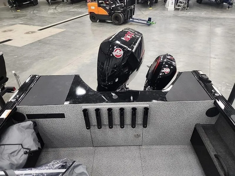 Slide: The Image of 2024 Crestliner 2050 Commander Elite boat with dual outboard motors in a showroom. - 10