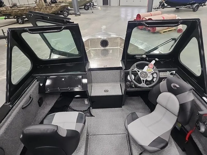 Slide: The Image of Interior of 2024 Crestliner 2050 Commander Elite boat with dual seats and steering console. - 11