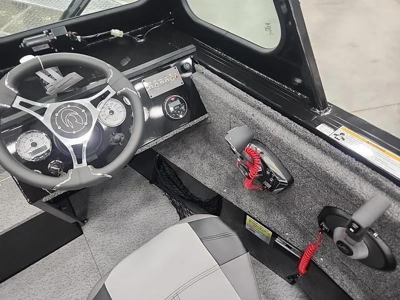 Slide: The Image of 2024 Crestliner 2050 Commander Elite boat interior with steering wheel and control panel. - 13