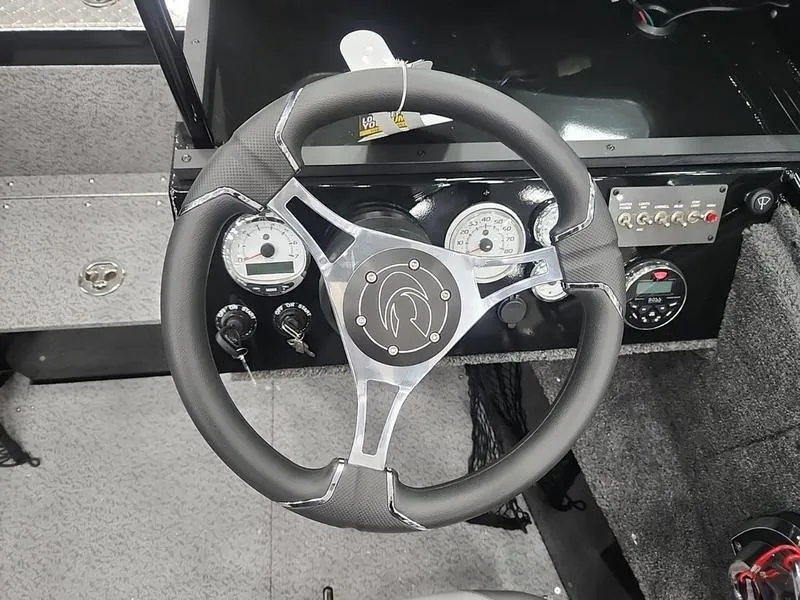 Slide: The Image of 2024 Crestliner 2050 Commander Elite dashboard with steering wheel and gauges. - 14