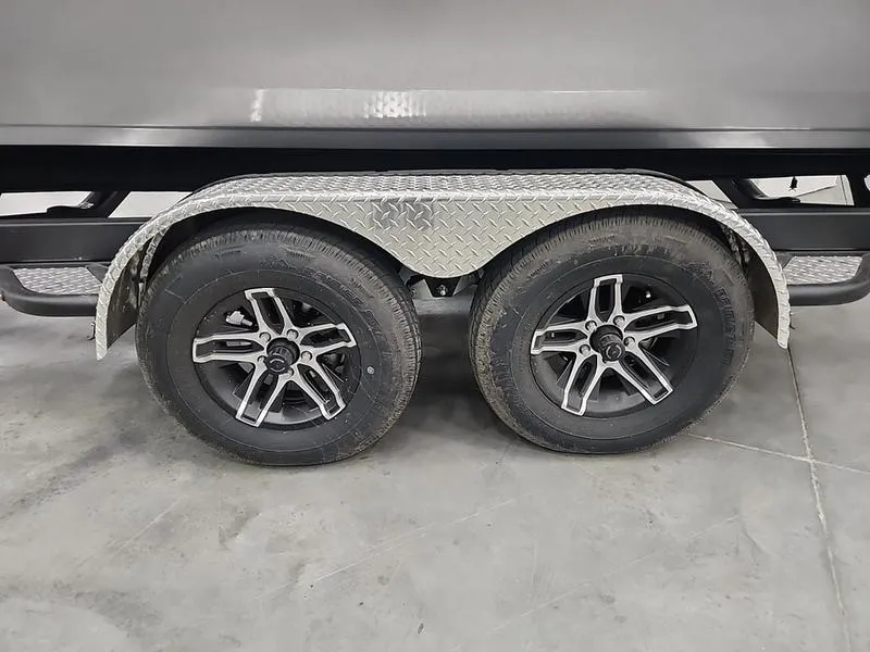 Slide: The Image of 2024 Crestliner 2050 Commander Elite trailer wheels with diamond plate fender. - 19