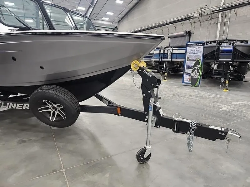 Slide: The Image of 2024 Crestliner 2050 Commander Elite boat on trailer in showroom. - 21