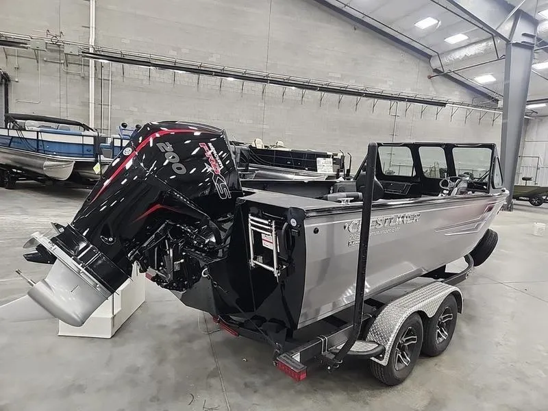 Slide: The Image of 2024 Crestliner 2050 Commander Elite boat with powerful outboard motor in a showroom. - 3