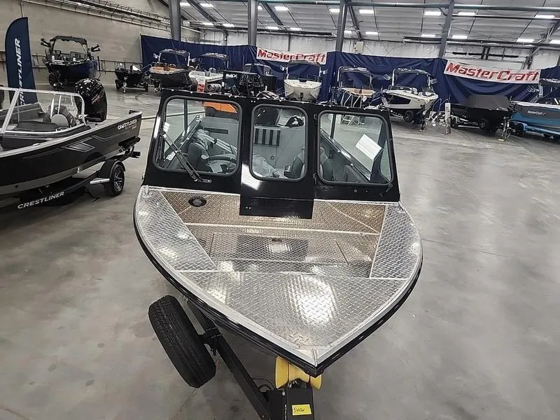 Slide: The Image of 2024 Crestliner 2050 Commander Elite boat in showroom, featuring sleek design and spacious interior. - 8