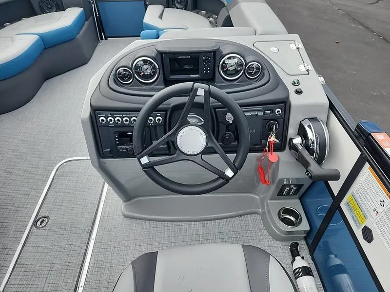 Slide: The Image of 2024 South Bay S224FCR 3.0 boat dashboard with steering wheel and control panel. - 12