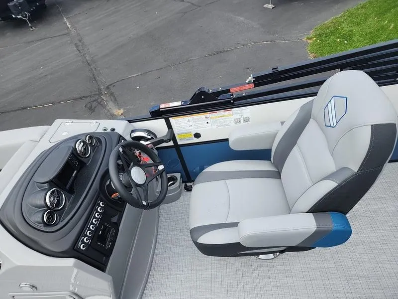 Slide: The Image of 2024 South Bay S224FCR 3.0 boat interior with steering wheel and captain's chair. - 13