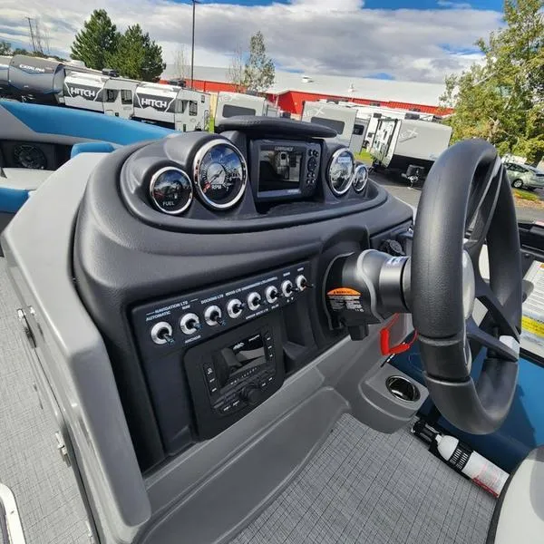 Slide: The Image of 2024 South Bay S224FCR 3.0 boat dashboard with steering wheel and control panel. - 14