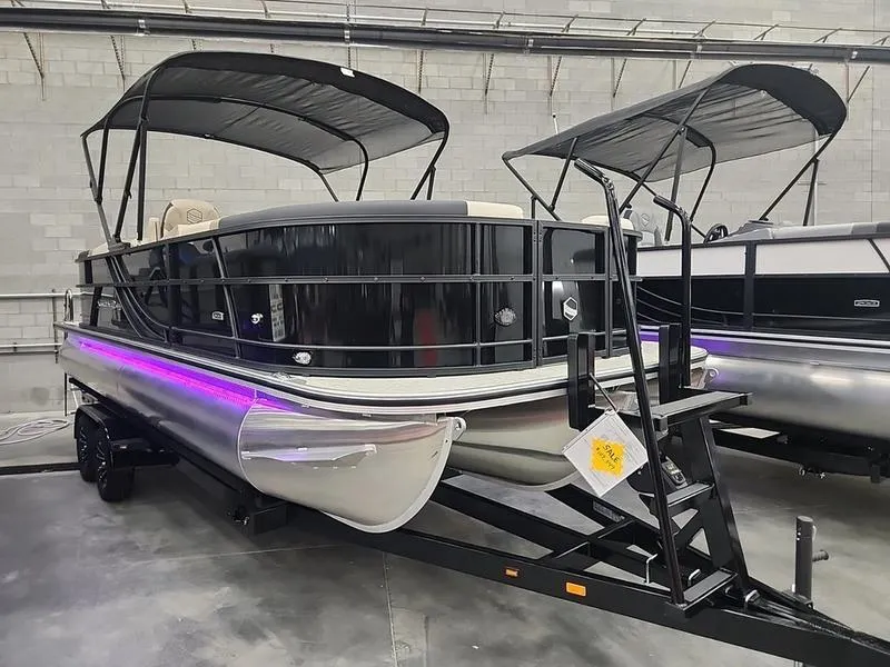 Slide: The Image of 2024 South Bay S224RS 3.0 pontoon boat with canopy in showroom. - 1