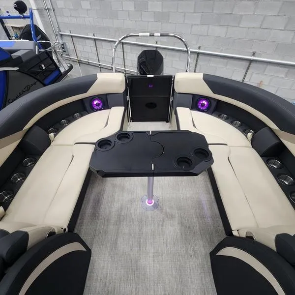 Slide: The Image of 2024 South Bay S224RS 3.0 pontoon boat interior with plush seating and cup holders. - 10