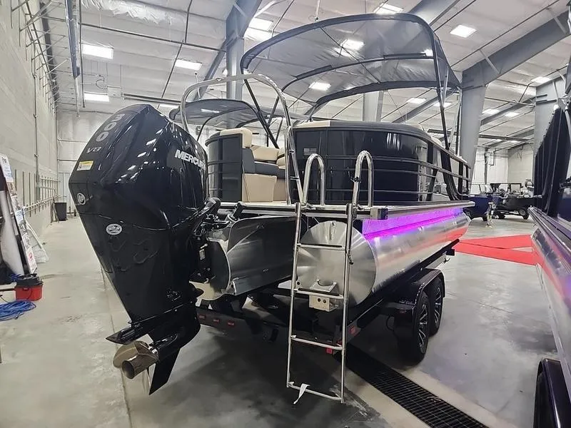 Slide: The Image of 2024 South Bay S224RS 3.0 pontoon boat with Mercury engine in showroom. - 2