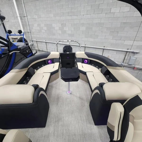 Slide: The Image of 2024 South Bay S224RS 3.0 pontoon boat interior with plush seating and ambient lighting. - 9