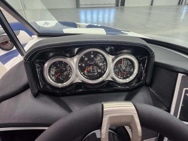 Slide: The Image of 2023 MasterCraft XT22-T dashboard with speedometer and gauges in a sleek design. - 12