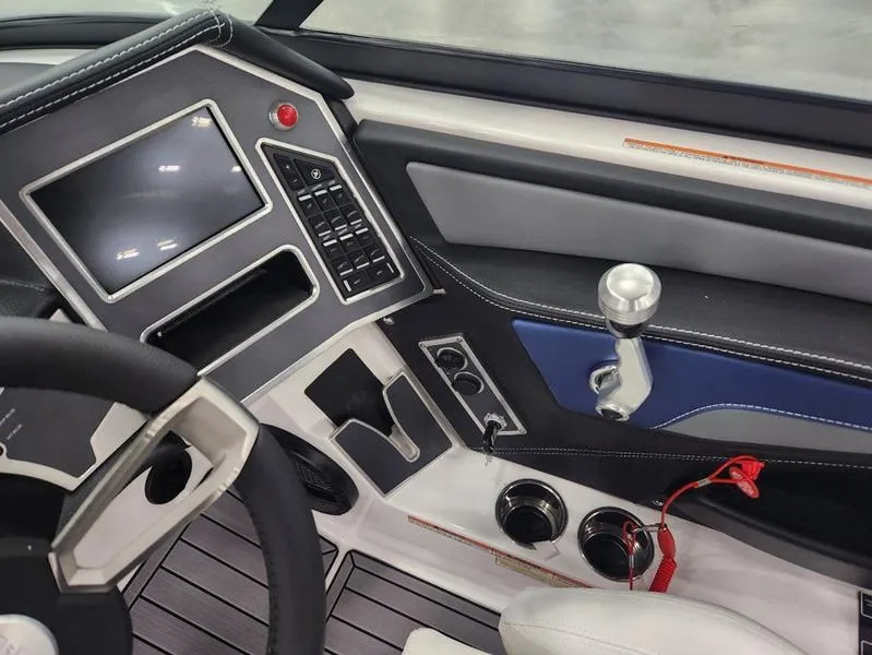 Slide: The Image of 2023 MasterCraft XT22-T boat dashboard with touchscreen and controls. - 13