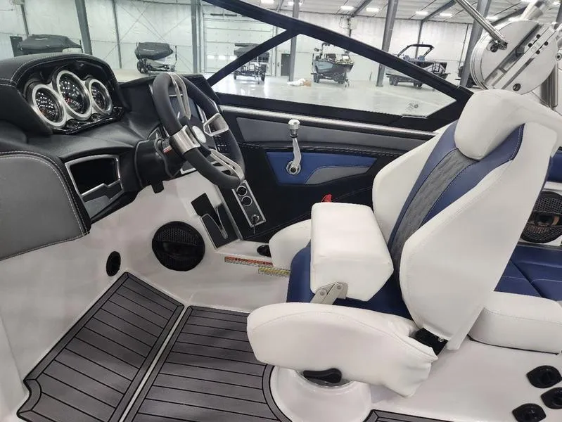 Slide: The Image of 2023 MasterCraft XT22-T boat interior with modern dashboard and comfortable seating. - 14