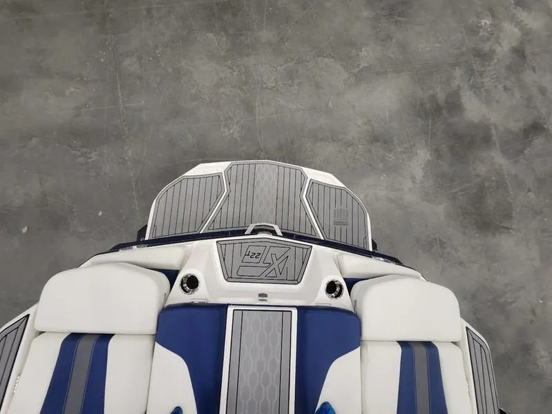 Slide: The Image of 2023 MasterCraft XT22-T boat interior with blue and white upholstery, top view. - 19