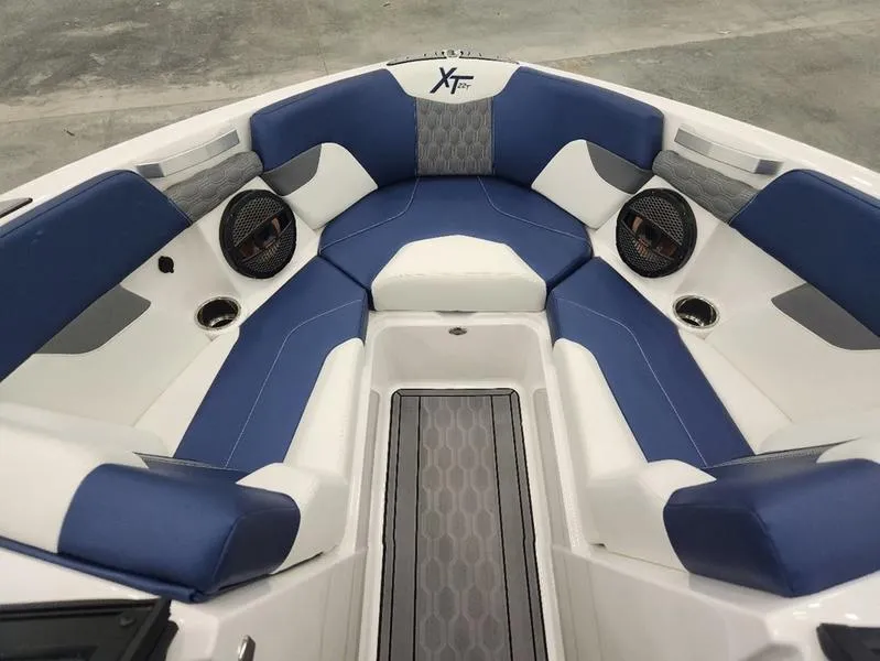 Slide: The Image of 2023 MasterCraft XT22-T boat interior with blue and white seating. - 24