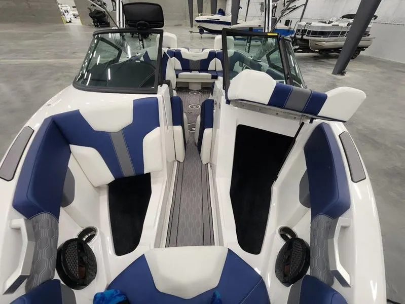 Slide: The Image of 2023 MasterCraft XT22-T boat interior with blue and white seating, modern design. - 25