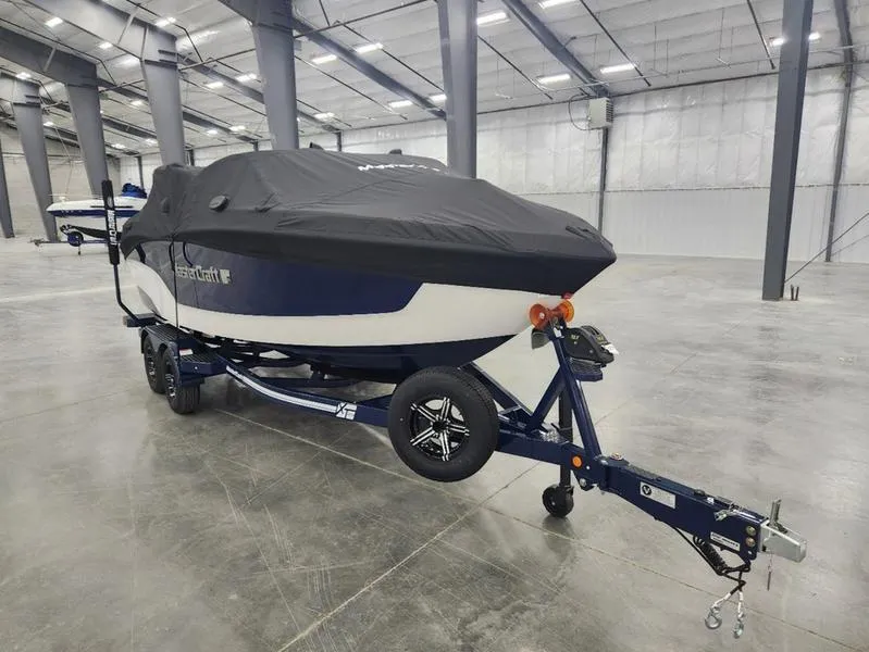 Slide: The Image of 2023 MasterCraft XT22-T boat with cover on trailer in warehouse. - 28