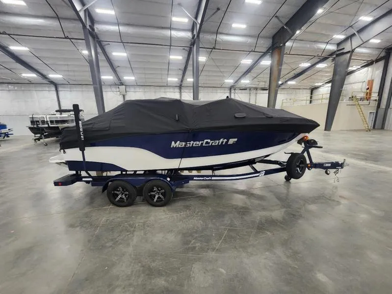 Slide: The Image of 2023 MasterCraft XT22-T boat covered in a warehouse setting. - 30