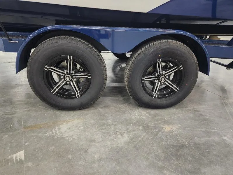 Slide: The Image of 2023 MasterCraft XT22-T trailer with dual black alloy wheels. - 34