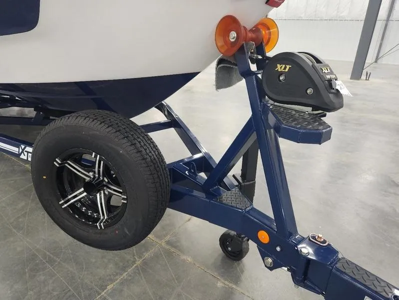 Slide: The Image of 2023 MasterCraft XT22-T boat trailer with XLT winch in a showroom. - 36