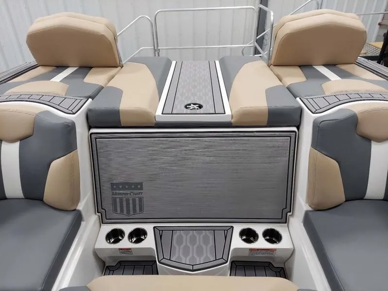 Slide: The Image of 2023 MasterCraft XT23 boat interior with gray and beige seating. - 14