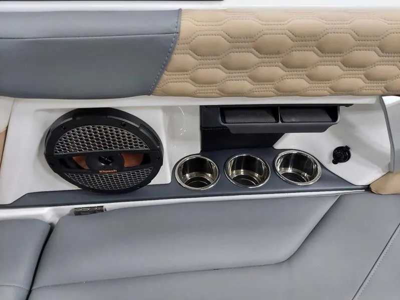 Slide: The Image of 2023 MasterCraft XT23 interior with speaker, cup holders, and stylish upholstery. - 18