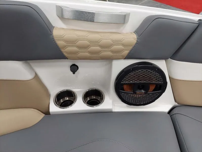Slide: The Image of 2023 MasterCraft XT23 boat interior with cup holders and speaker. - 19