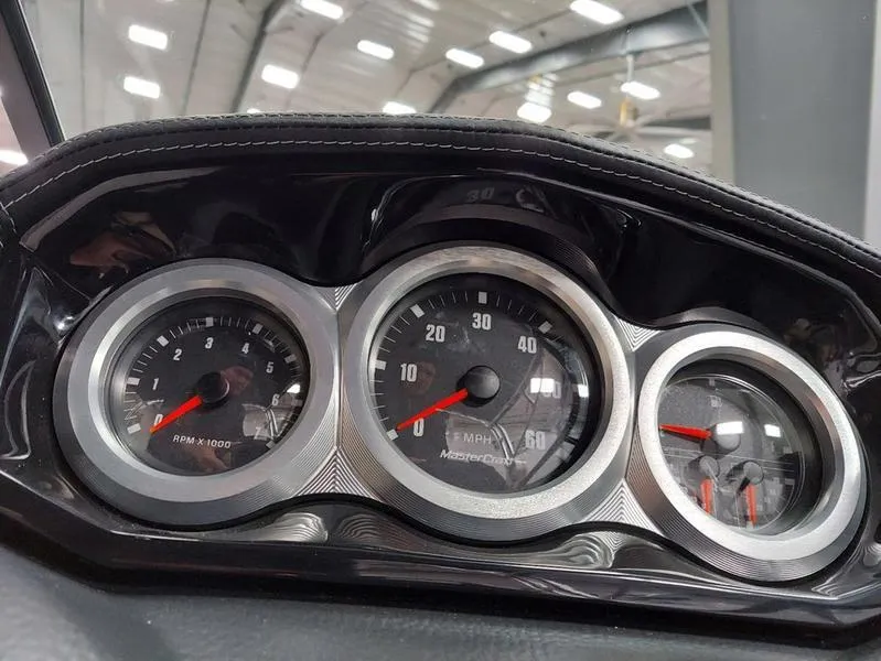 Slide: The Image of Dashboard of 2023 MasterCraft XT23 boat with speedometer and tachometer gauges. - 21