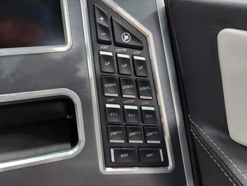 Slide: The Image of Control panel of 2023 MasterCraft XT23 boat with various buttons and functions. - 22