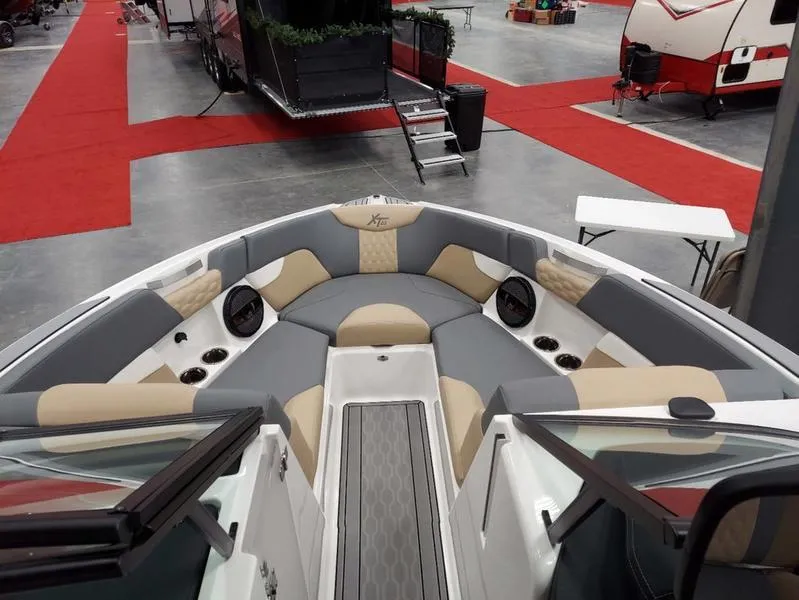 Slide: The Image of 2023 MasterCraft XT23 boat interior with stylish seating and modern design. - 24