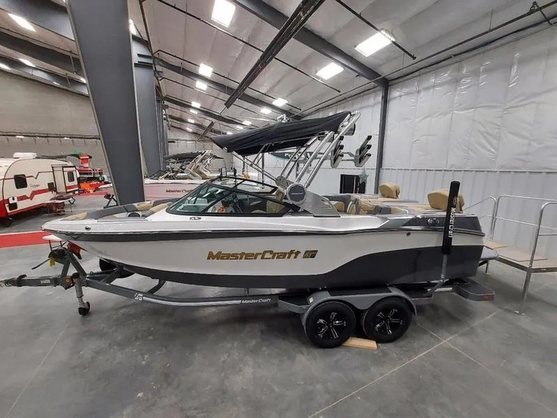 Slide: The Image of 2023 MasterCraft XT23 boat displayed indoors on a trailer. - 6