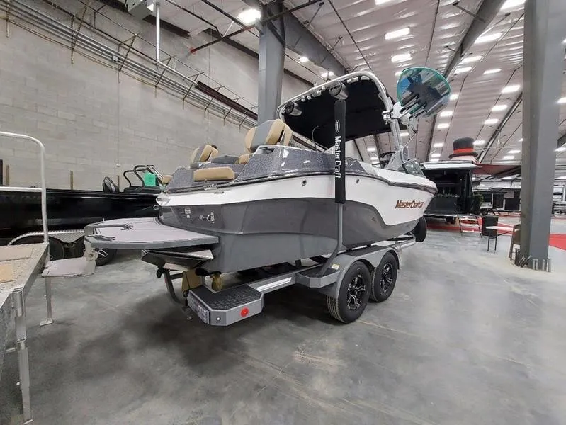 Slide: The Image of 2023 MasterCraft XT23 boat on trailer in indoor showroom. - 7