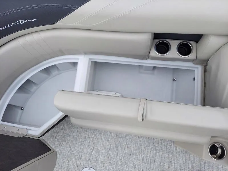 Slide: The Image of 2023 South Bay 220CR LE boat interior storage compartment with cup holders. - 10