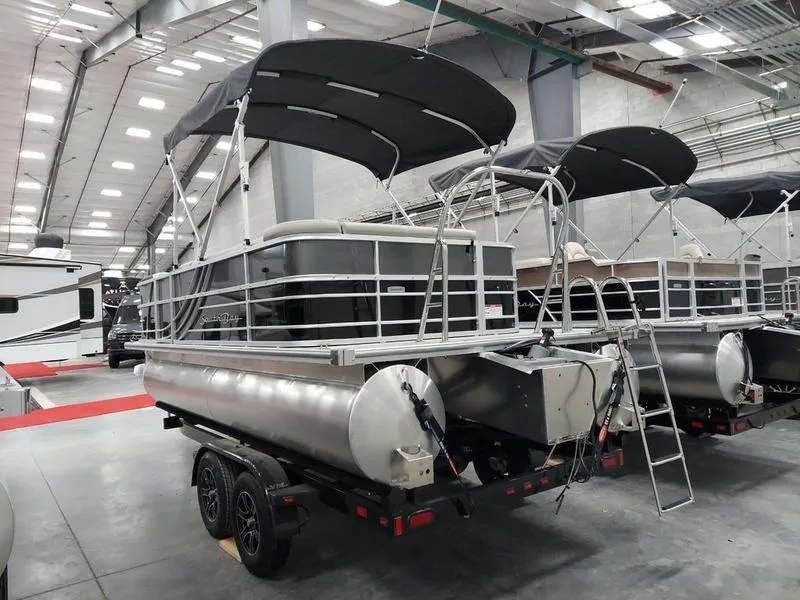 Slide: The Image of 2023 South Bay 220CR LE pontoon boat in showroom, side view. - 4