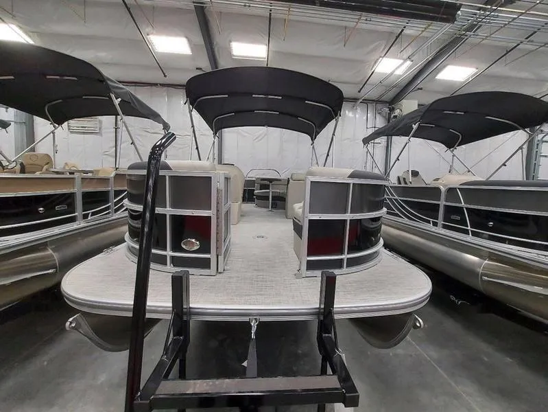 Slide: The Image of 2023 South Bay 220CR LE pontoon boat in indoor storage facility. - 7