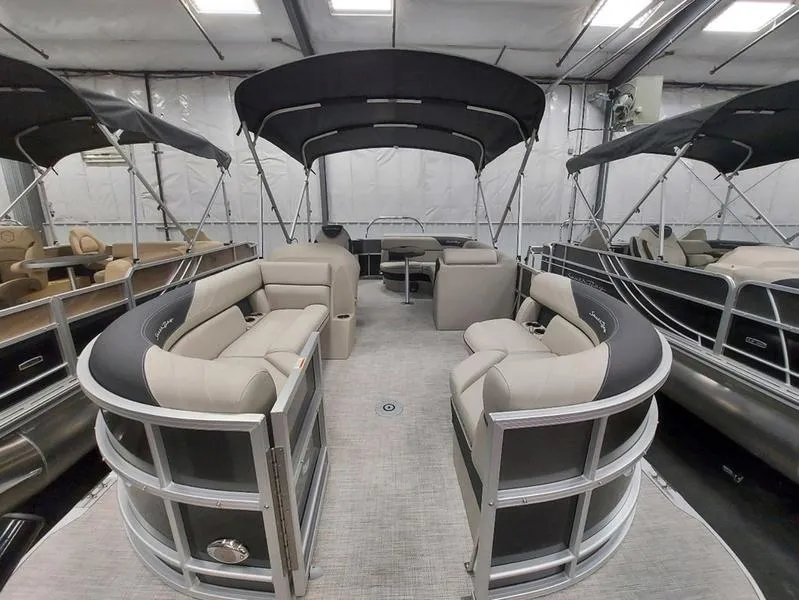 Slide: The Image of 2023 South Bay 220CR LE 25" pontoon boat interior with seating and canopy. - 8